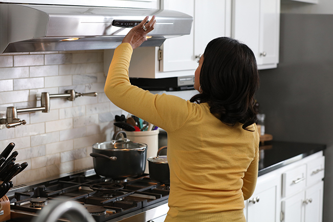 Person cooking on kitchen stove