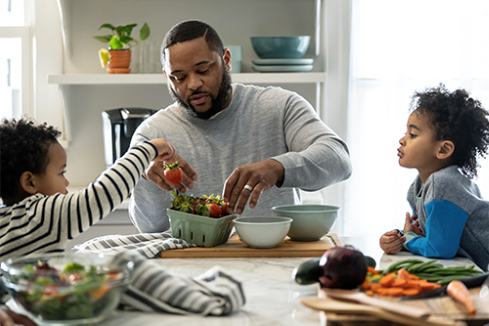 Family preparing dinner at a table